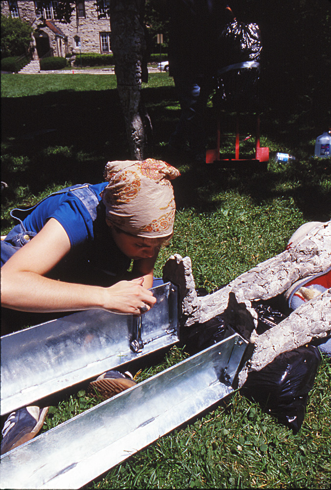 Two Are Halves of One. 2001. Ceramic and stainless steel. Dimensions variable. Studio assistant installing anchors to base of figures. Darrin Hallowell