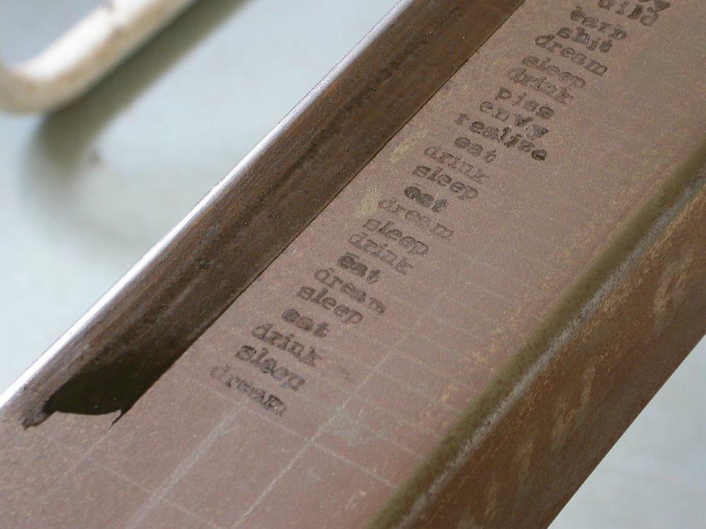 Eat Sleep Drink Dream. 2007. Steel. 49 x 7 x 10. Applying words to back of piece. Darrin Hallowell